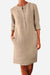 Khaki cotton dress with 3/4 rolled sleeves, front buttons, and pockets, casual knee-length style.